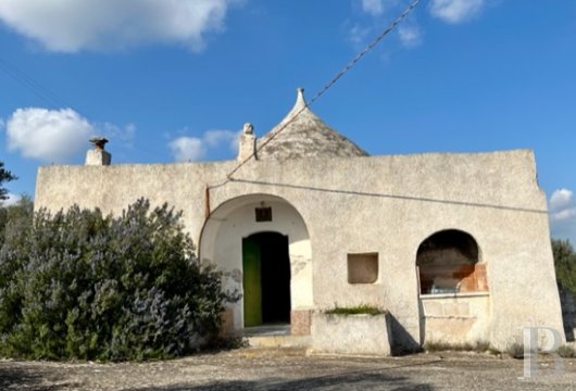Awaiting renovation, a traditional, dry stone “trullo”, with a view of the sea, in Ostuni in the region of Apulia