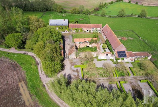 A farm complex with 22 hectares of land and a former abbey cloister,  nestled by the Franco-Belgian border near the city ...