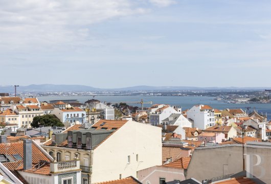 In the historic heart of Lisbon, a 19th-century apartment with a balcony overlooking the Tagus River.