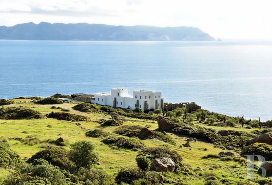 In Milos, a seaside villa overlooking the Aegean Sea and its volcanic waters