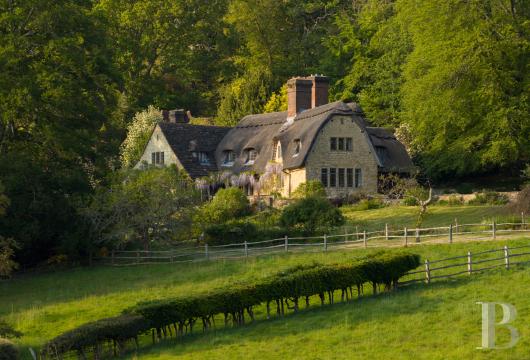 In Surrey, a stone mansion nestled between formal gardens and an oak forest, set on a preserved estate of some ...