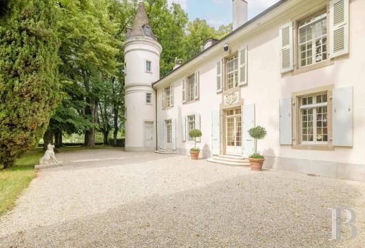 In the Geneva region, a stone castle nestled in the Lake Geneva countryside