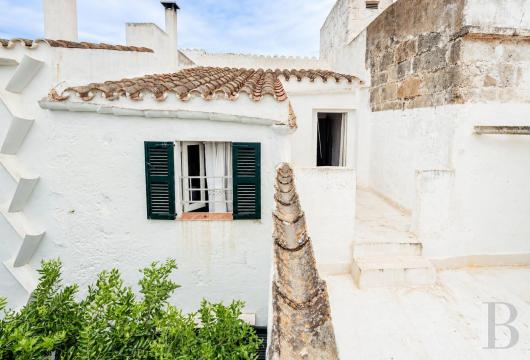 In Menorca, in the Sant Miquel neighbourhood of Ciutadella, a townhouse built of marès stone with a patio measuring ...