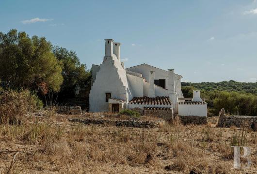 In Menorca, on the edge of the Barranc d’Algendar, a rural property in need of renovation, set amongst farmland, ...